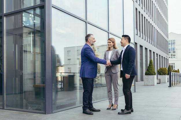 professional handshake in front of a German corporate headquarters