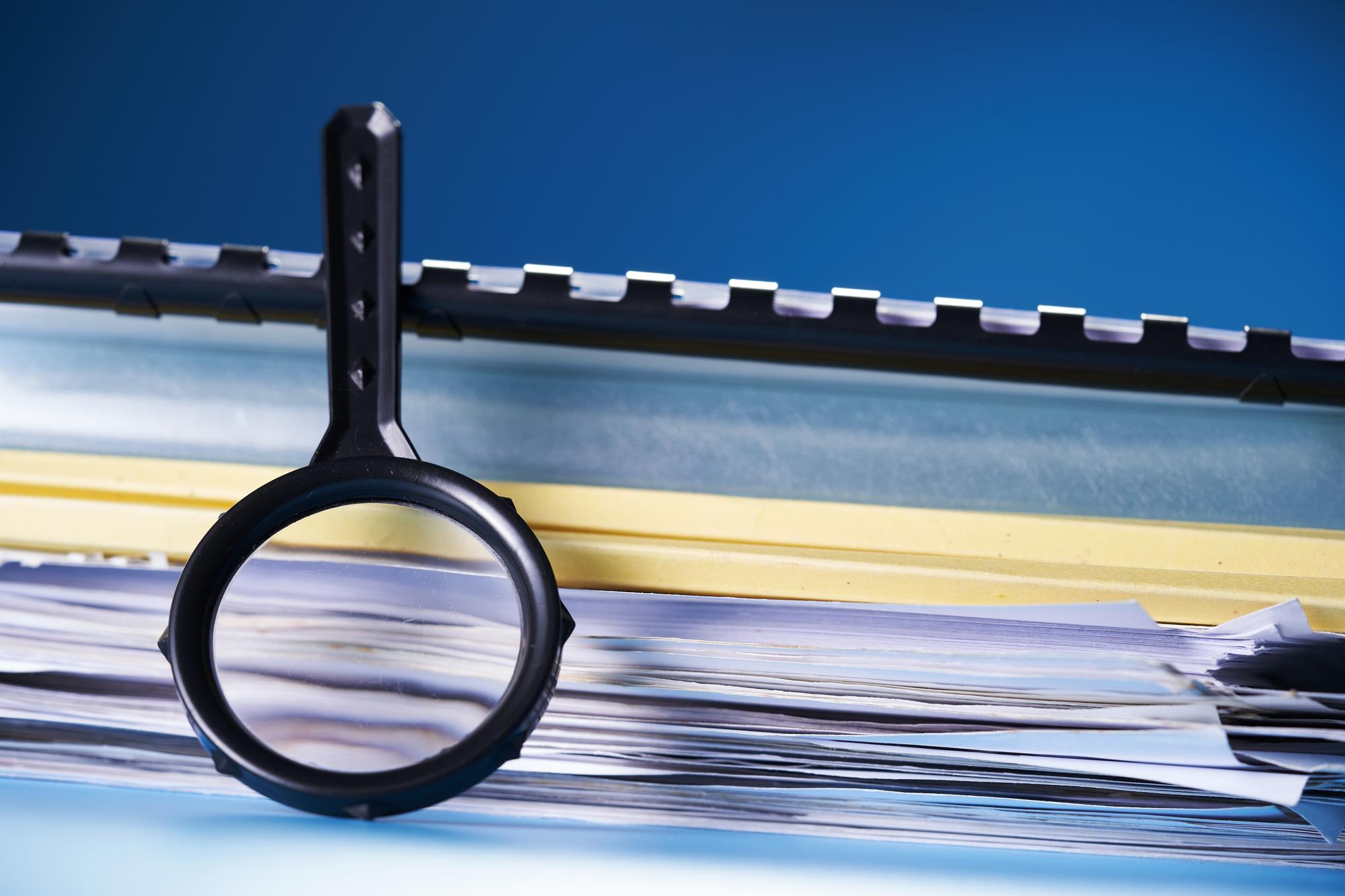 paperwork and magnifying glass