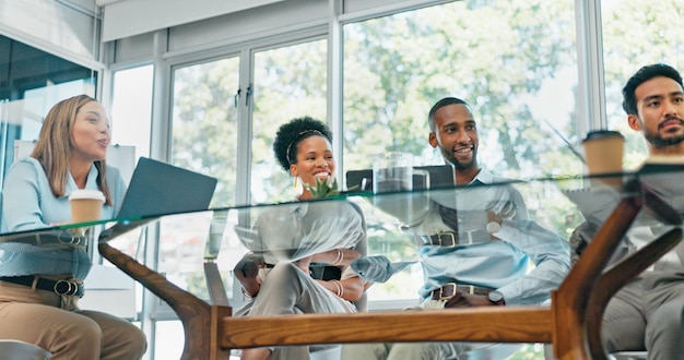 diverse group of professionals having a meeting in a glass-walled conference room